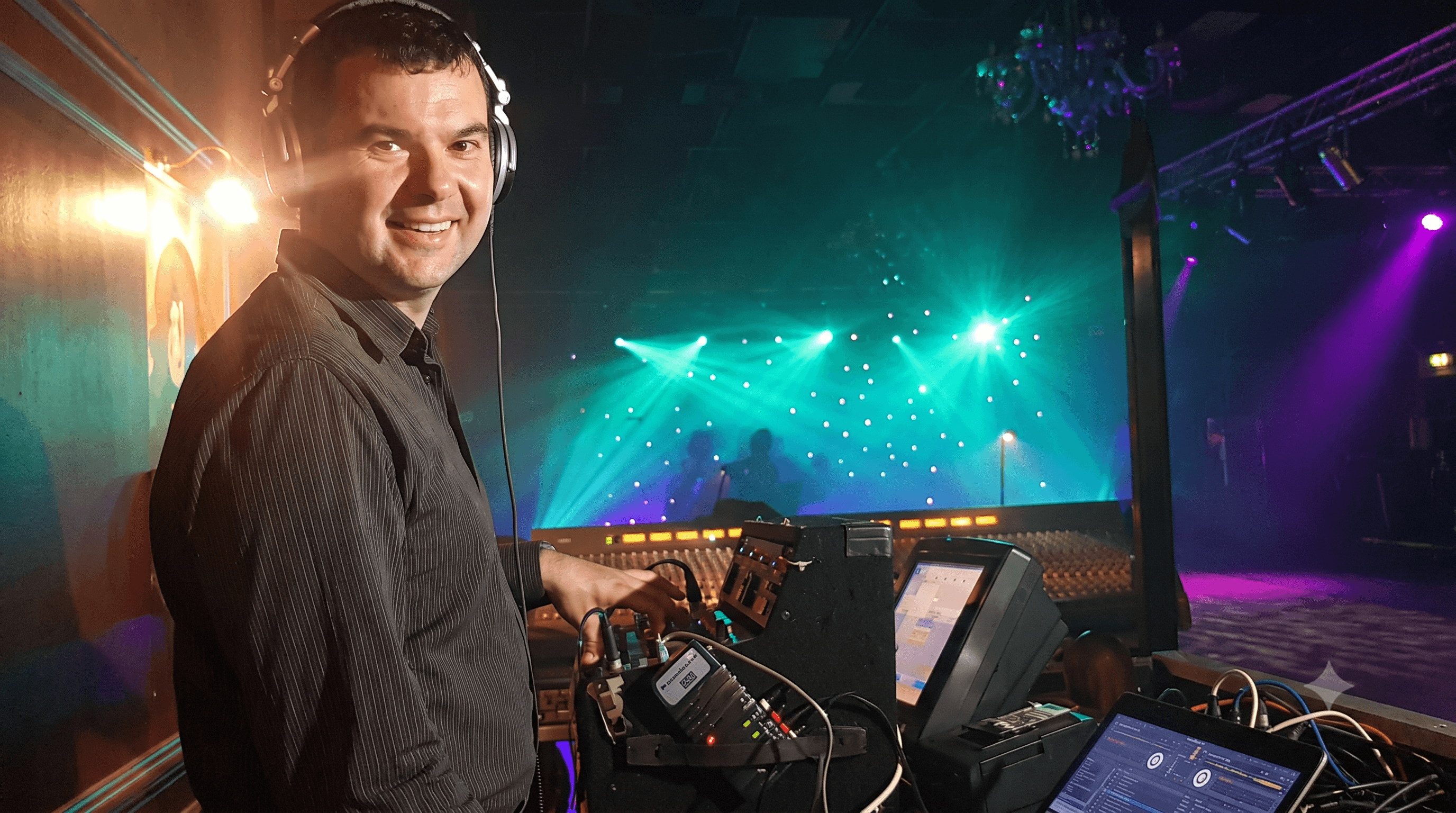 Alan Geraghty DJing under teal and purple lights