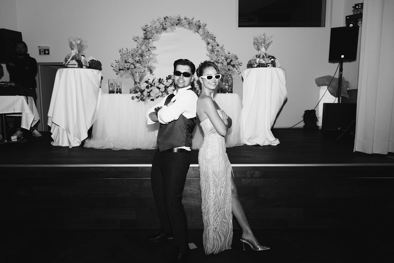 Stylish young couple posing at a formal event, capturing the essence of celebration.